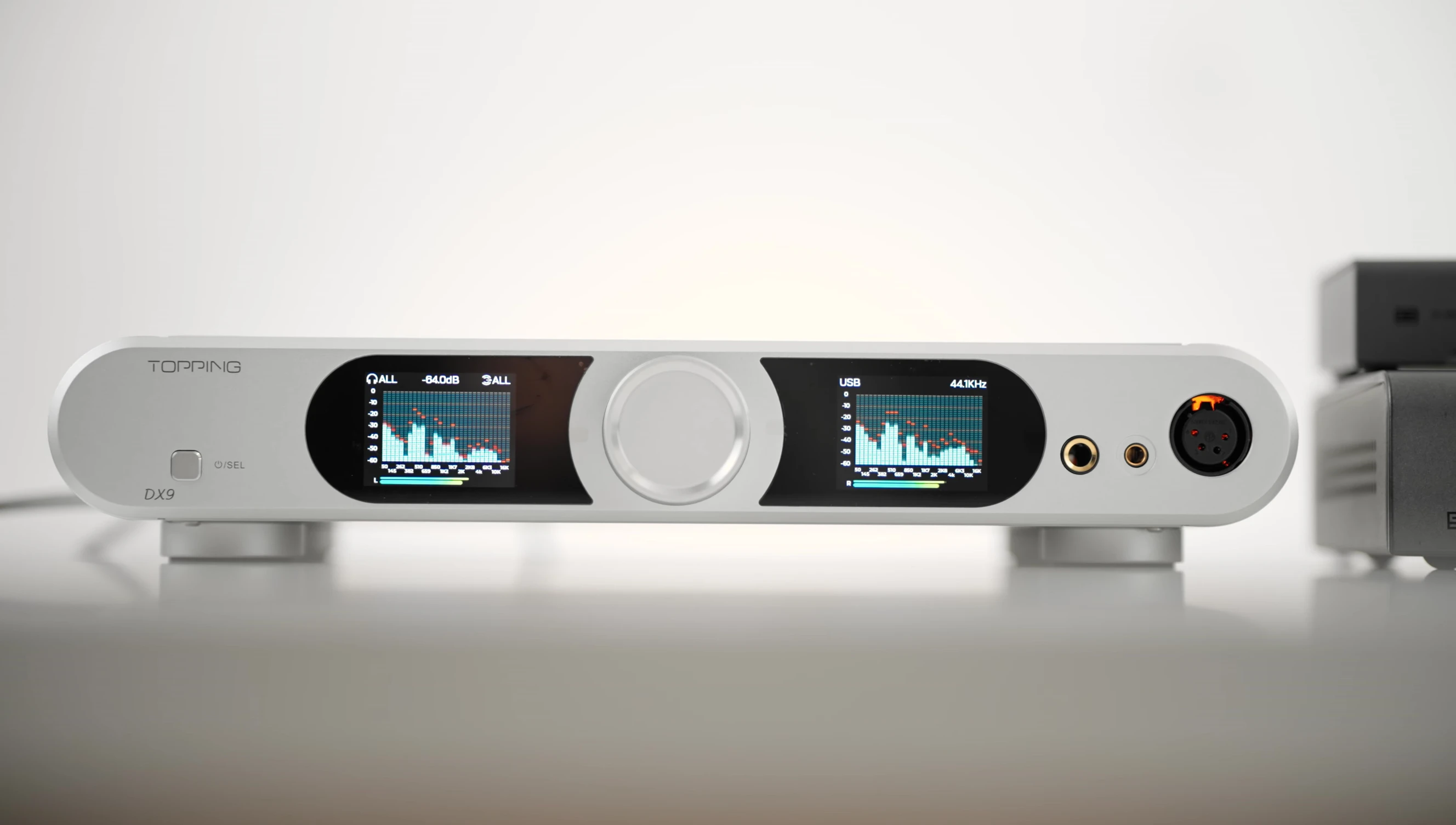 The Topping DX9 amplifier showing its front panel and display.