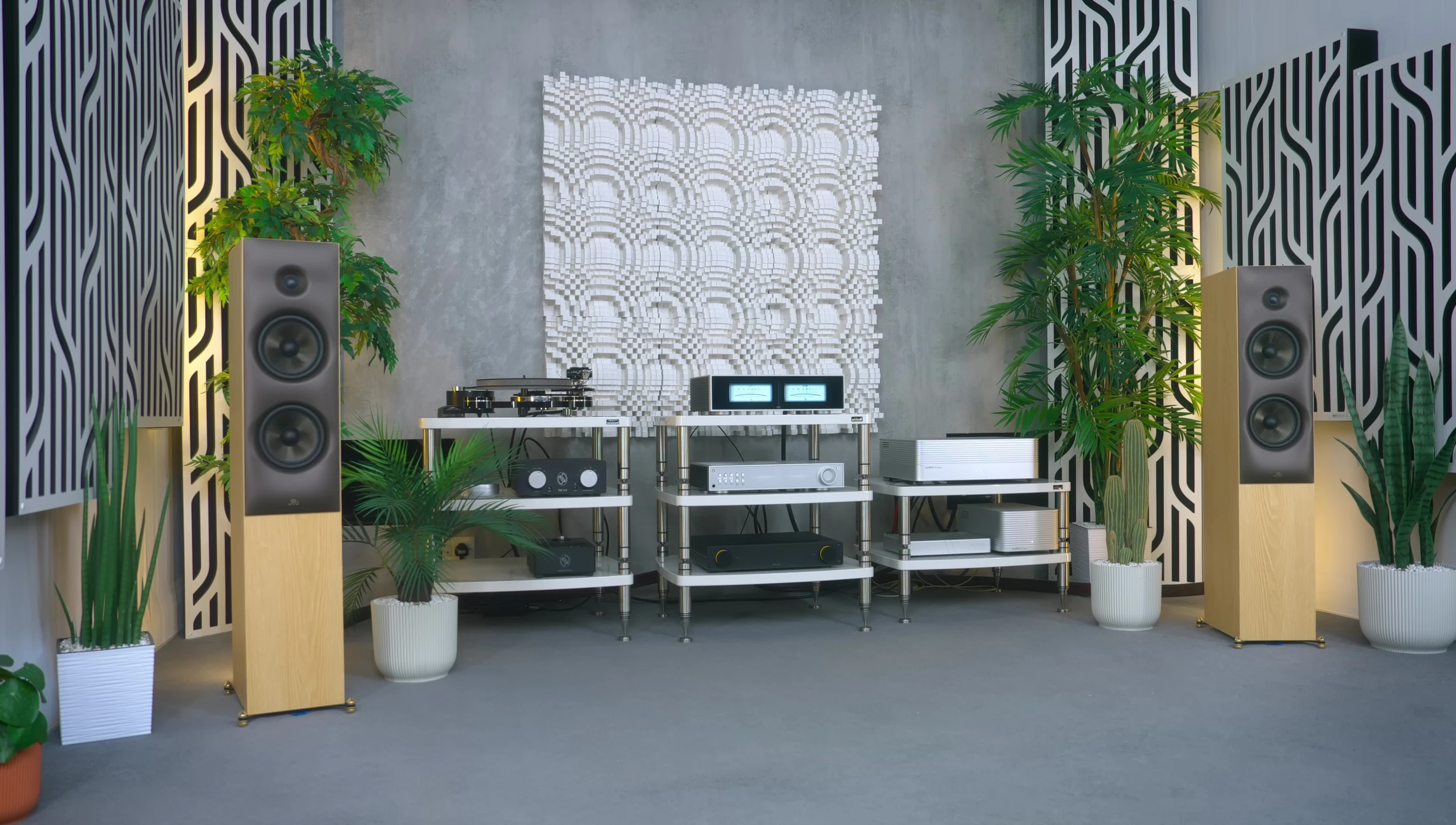 Another close-up shot of the reviewer's listening setup to emphasize the placement of speakers and their contribution to the sound.
