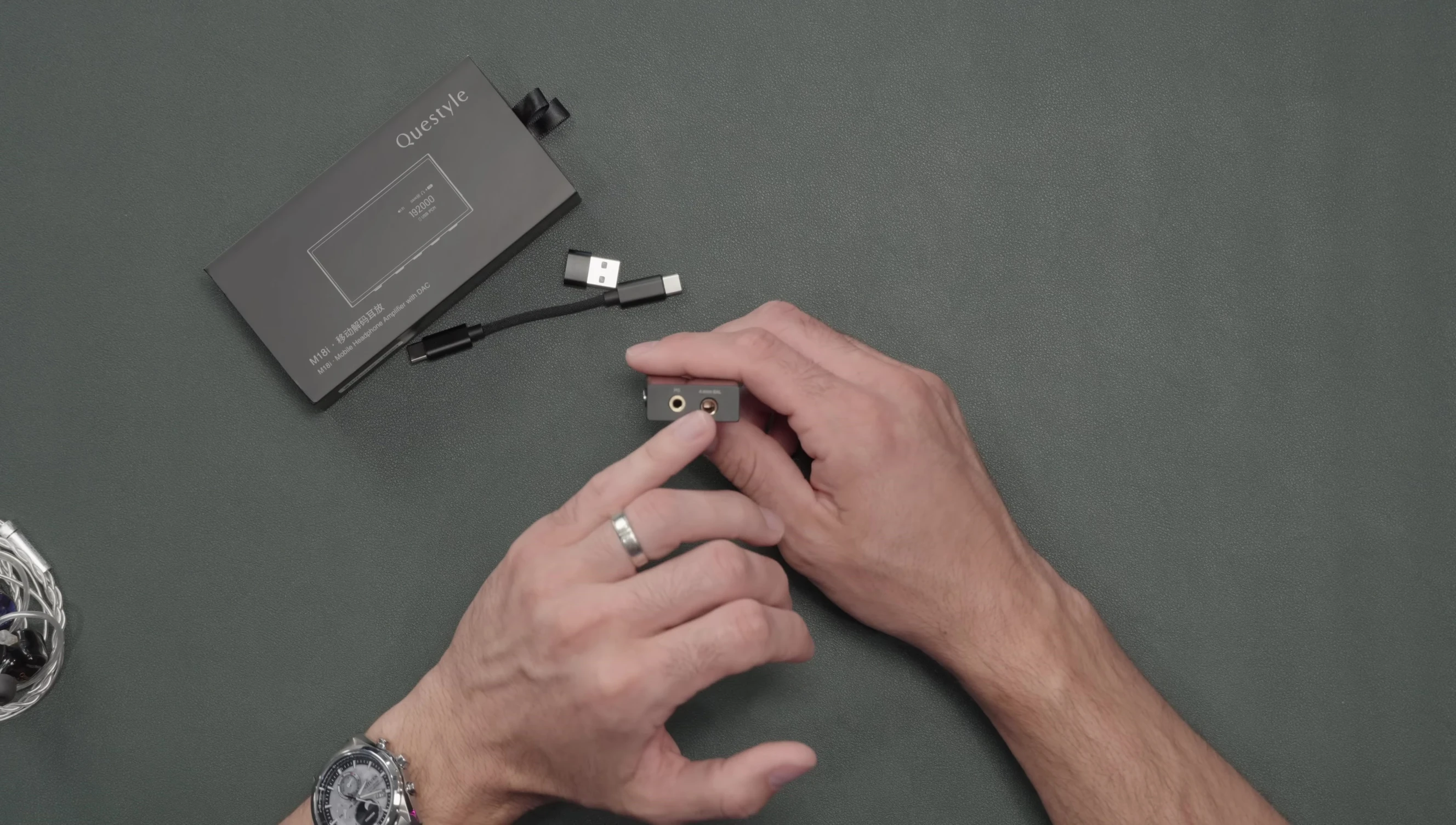 Close-up of the Questyle M18i showing its 3.5mm and 4.4mm outputs.