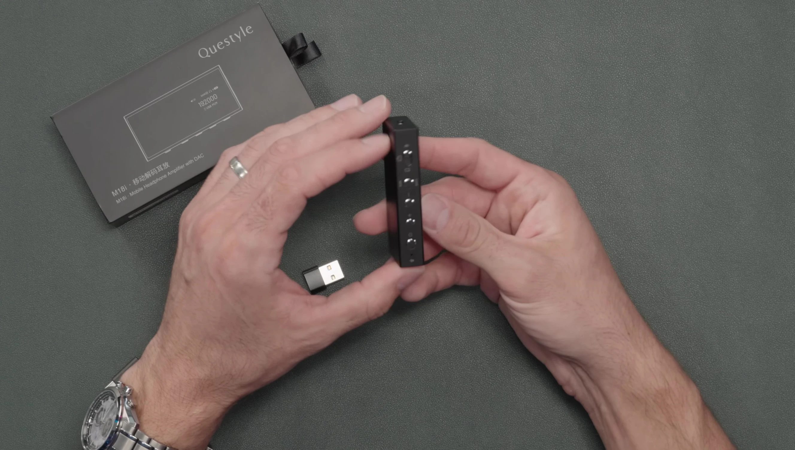 The mode switch on the Questyle M18i showing Bluetooth, PC and mobile icons.