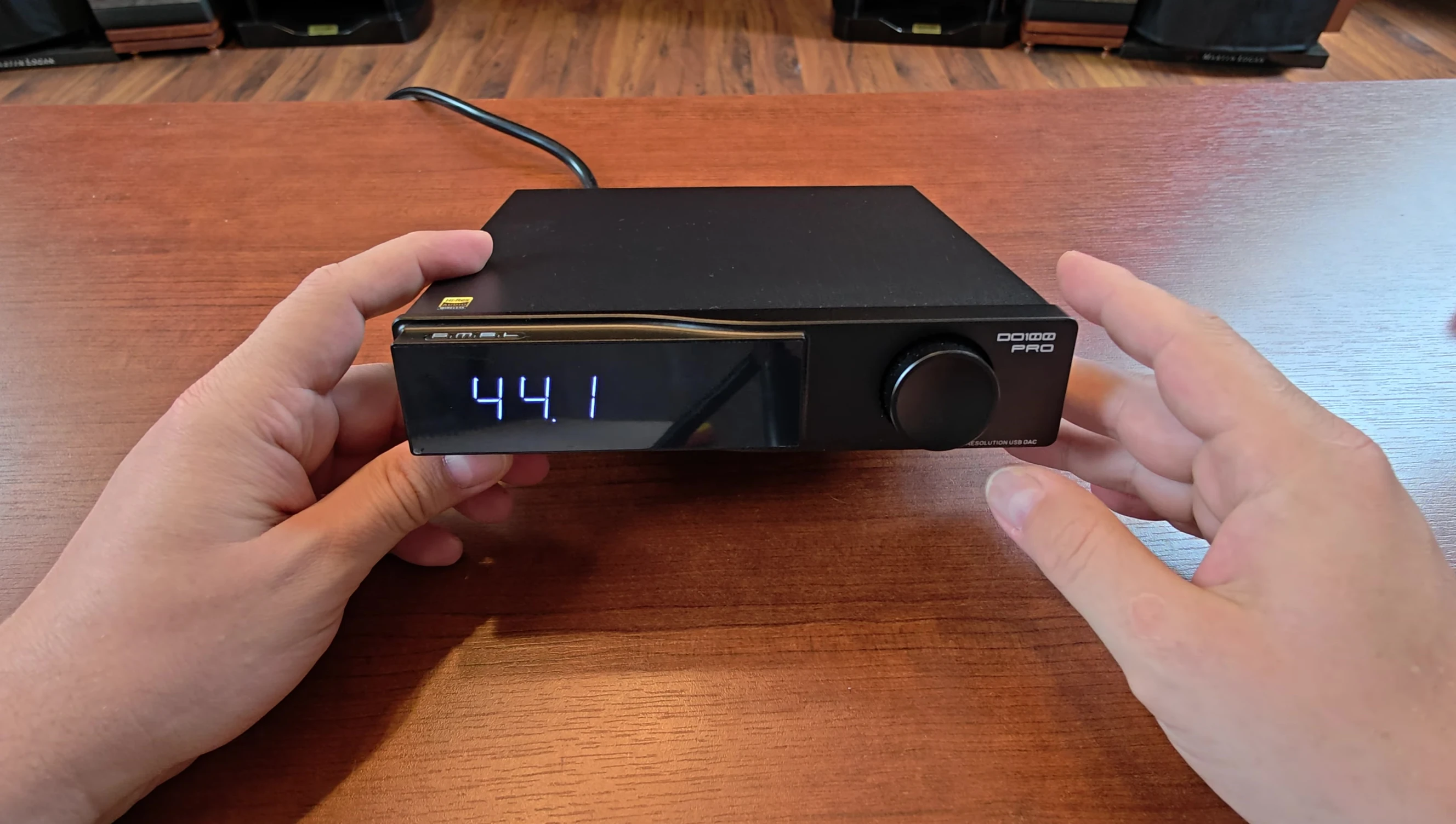 Front panel of the DO100 Pro showcasing the LCD display and rotary knob.
