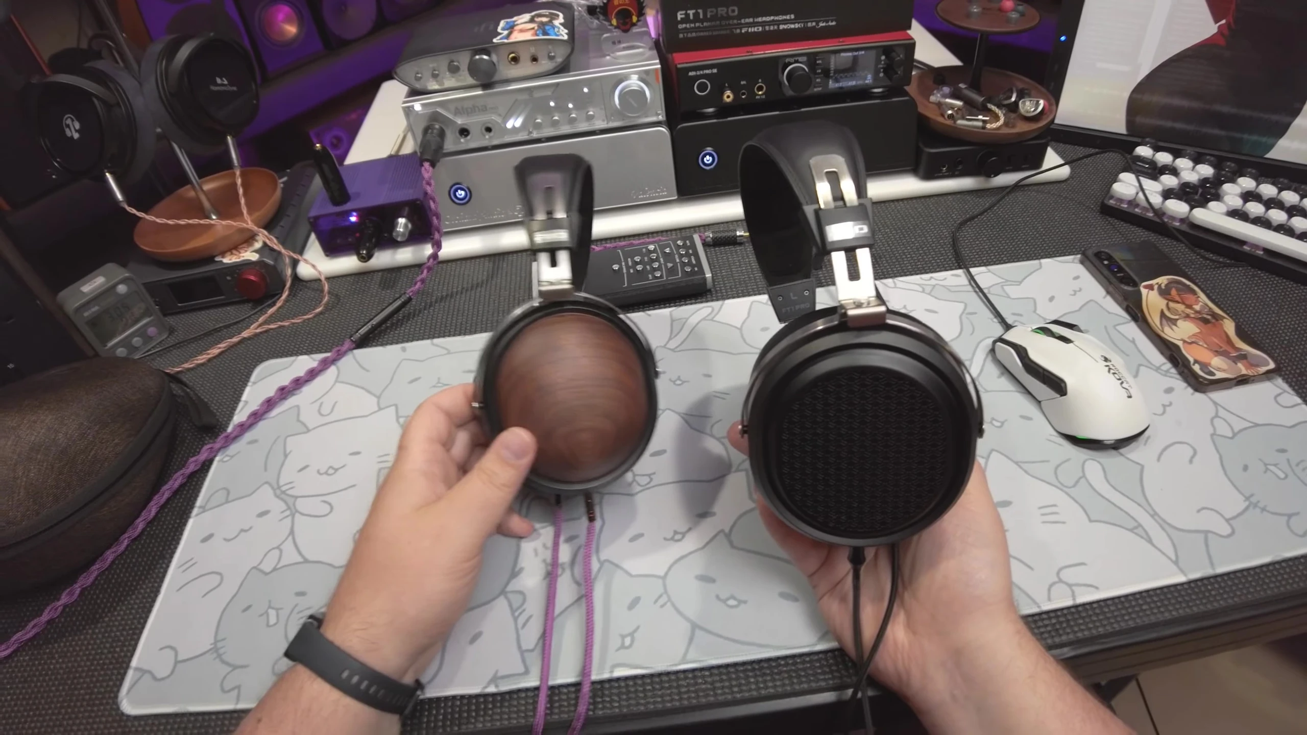 The reviewer putting on the headphones, indicating the start of a listening test