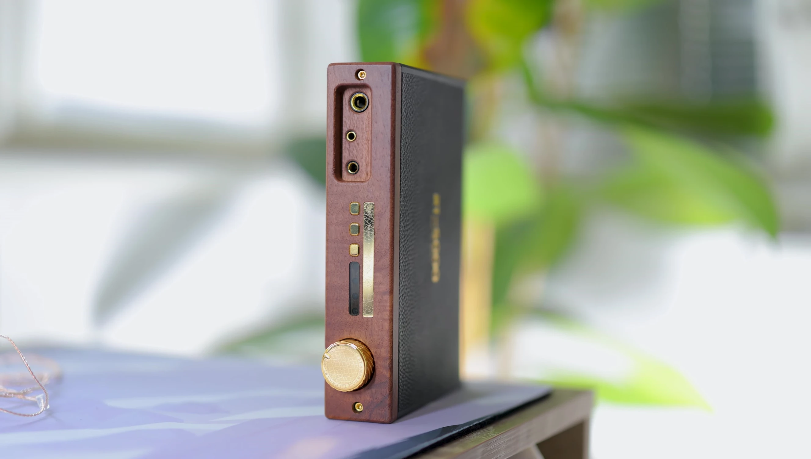 The large analog volume wheel and metal sides of the unit.