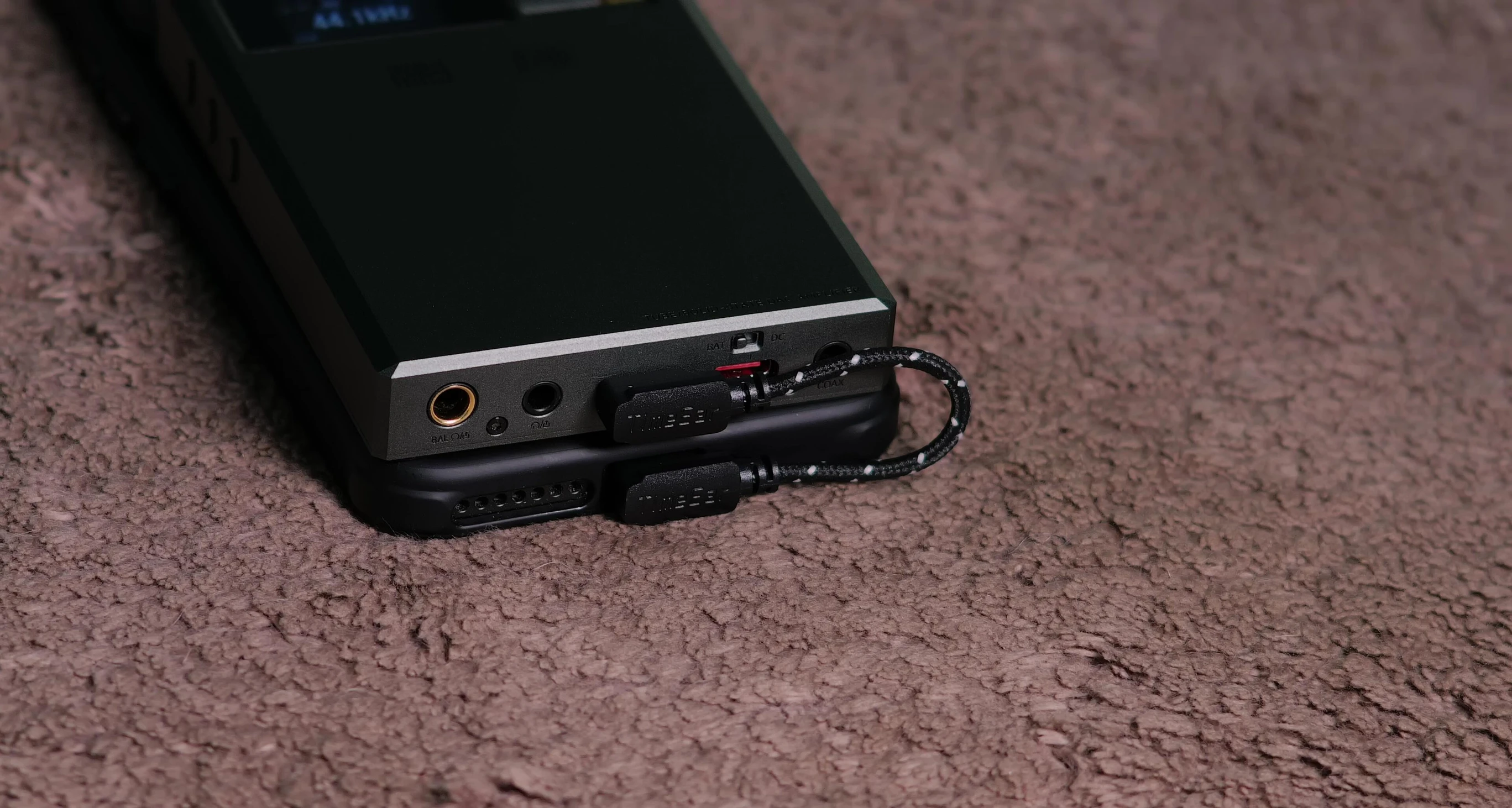 The RU9 connected to a phone with the short USB-C cable.
