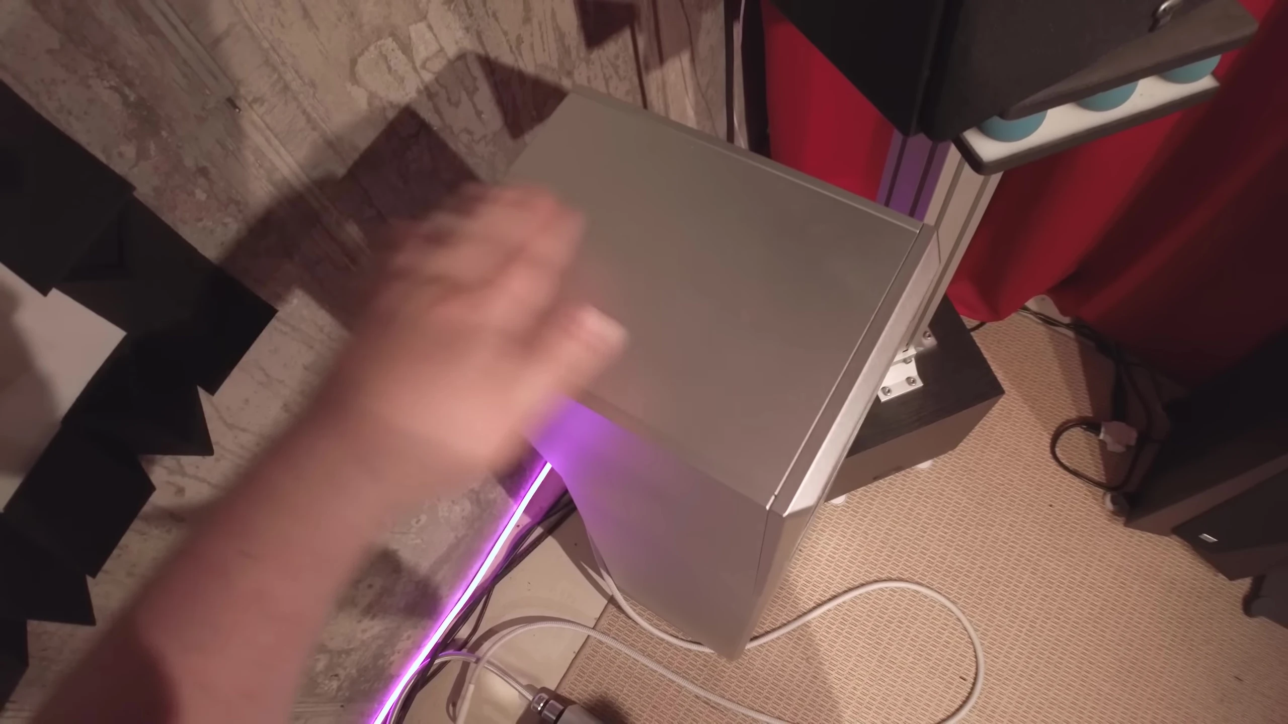 The reviewer showing the aluminum construction of the speakers
