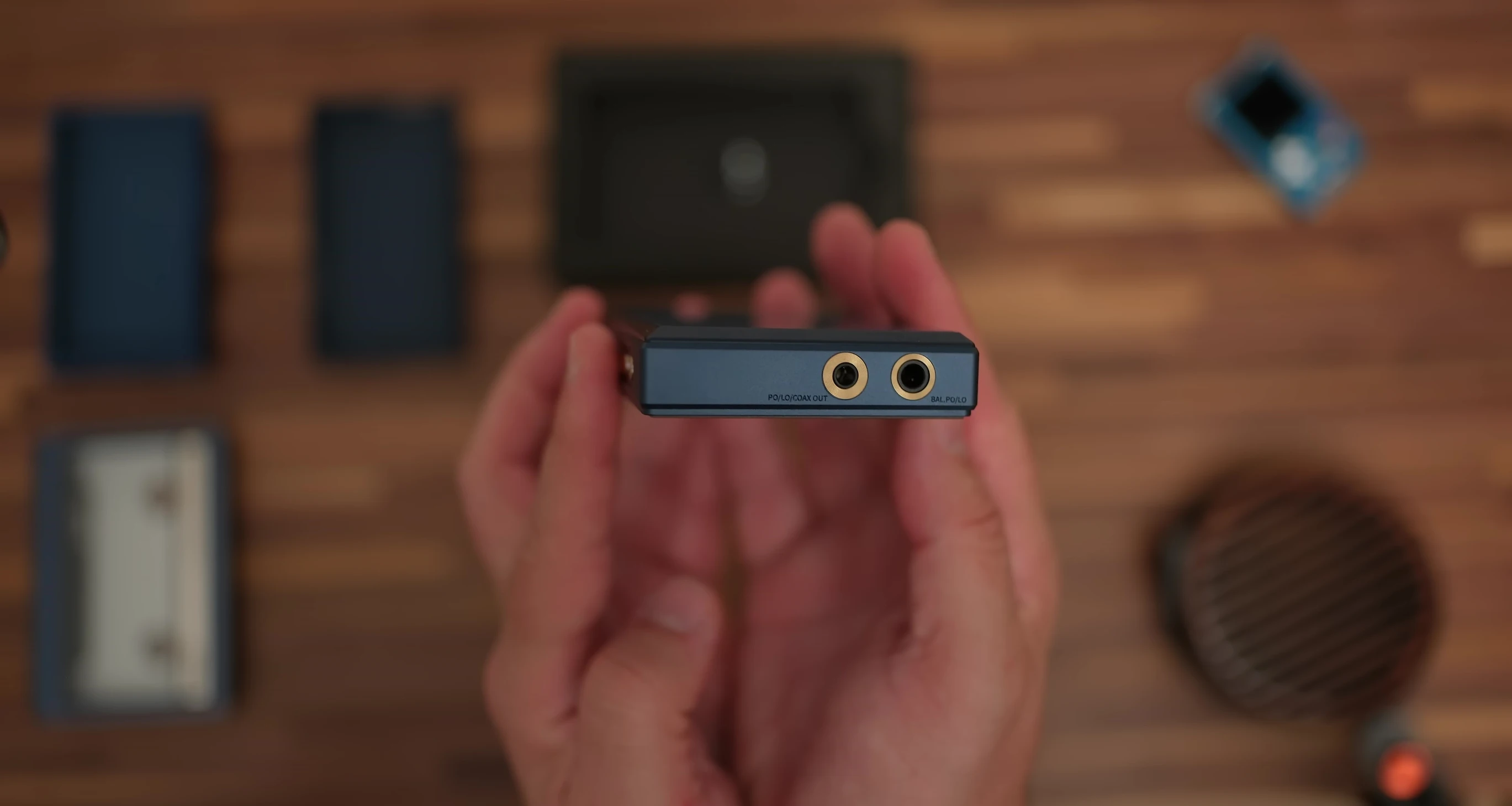 Image showcasing the dark blue FiiO M21 with bronze buttons.