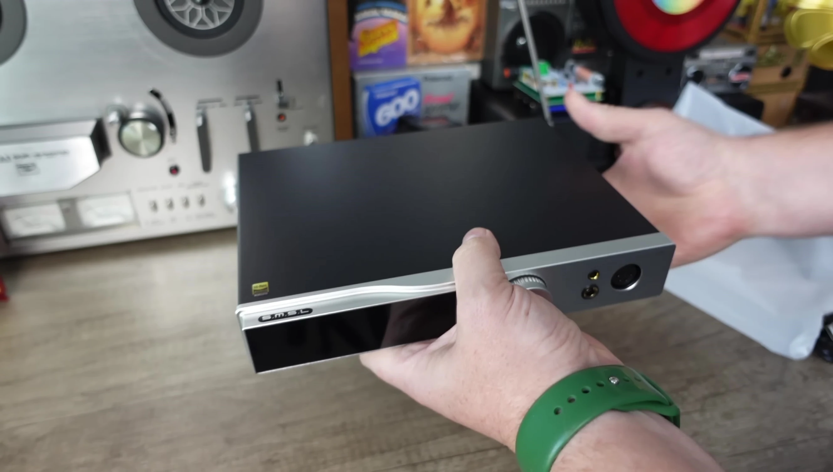 The reviewer holding the SMSL DO400, emphasizing its weight and build quality.