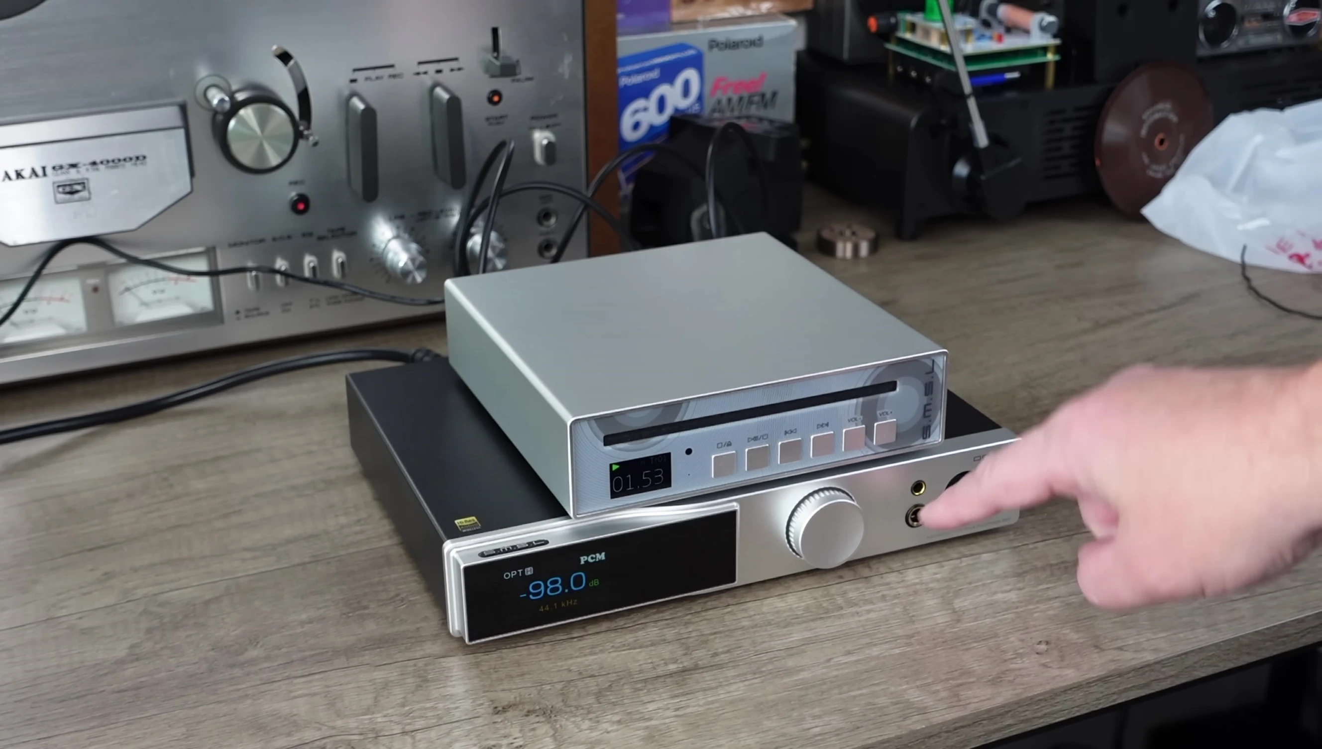 The reviewer preparing to switch between headphone outputs.